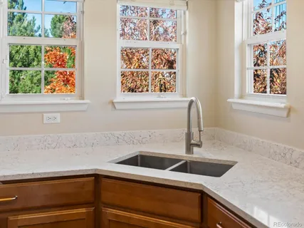 a view of a kitchen sink with wooden floor