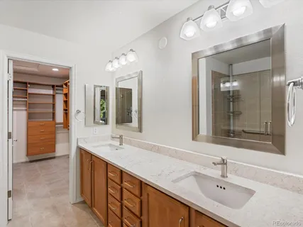 a bathroom with a sink double vanity and a mirror