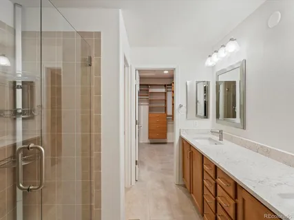 a bathroom with a granite countertop sink mirror and shower