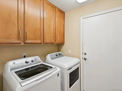 a view of washer and dryer with kitchen in the background