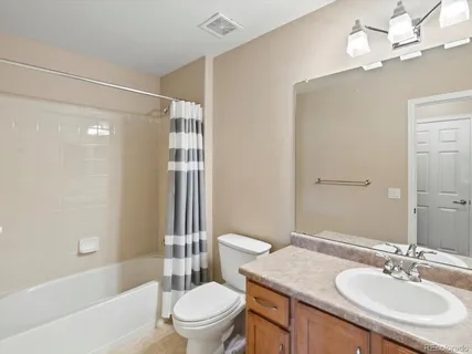 a bathroom with a sink toilet tub and shower