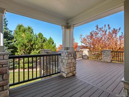 a balcony with furniture and wooden floor