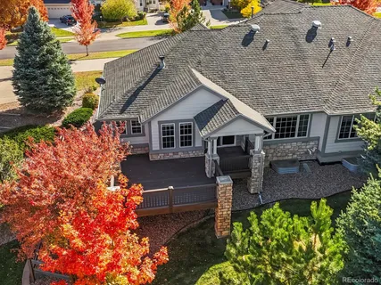 an aerial view of a house with a yard basket ball court and outdoor seating