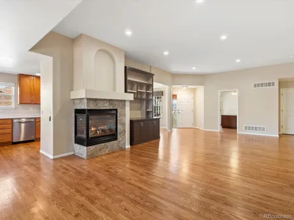 a view of a livingroom with a fireplace a fireplace and entryway