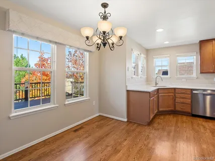 a view of a room with a window and wooden floor