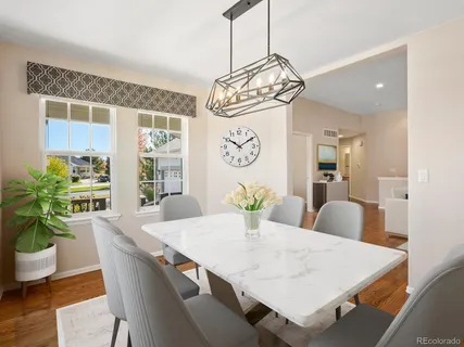 a view of a dining room with furniture and wooden floor