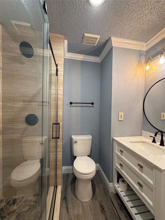 229 Travis Lane Hewitt, TX 76643 - Photo 11 of 17 a bathroom with a toilet a sink and glass door
