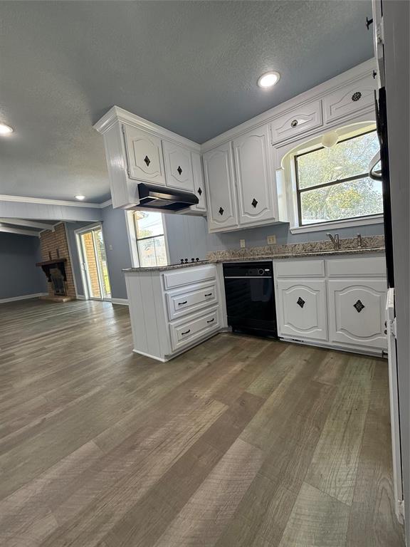 229 Travis Lane Hewitt, TX 76643 - Photo 15 of 17 a kitchen with stainless steel appliances granite countertop a stove a sink and white cabinets