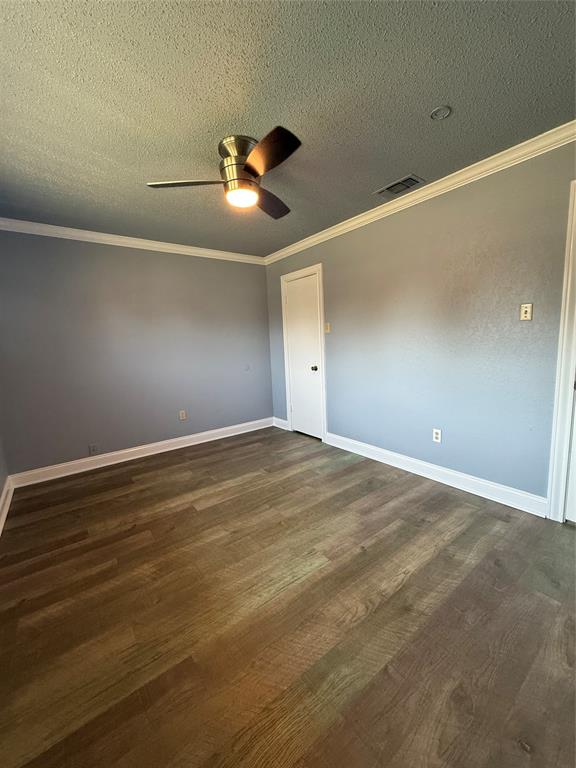 229 Travis Lane Hewitt, TX 76643 - Photo 7 of 17 a view of an empty room with wooden floor