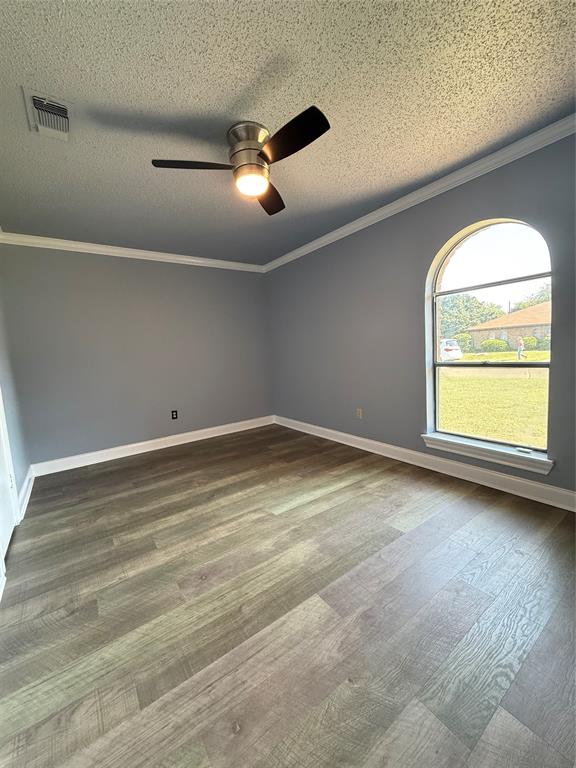 229 Travis Lane Hewitt, TX 76643 - Photo 8 of 17 an empty room with wooden floor and windows