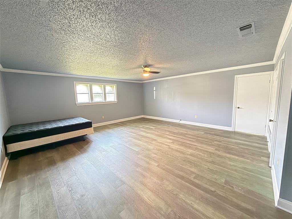 229 Travis Lane Hewitt, TX 76643 - Photo 10 of 17 a view of a room with wooden floor and window