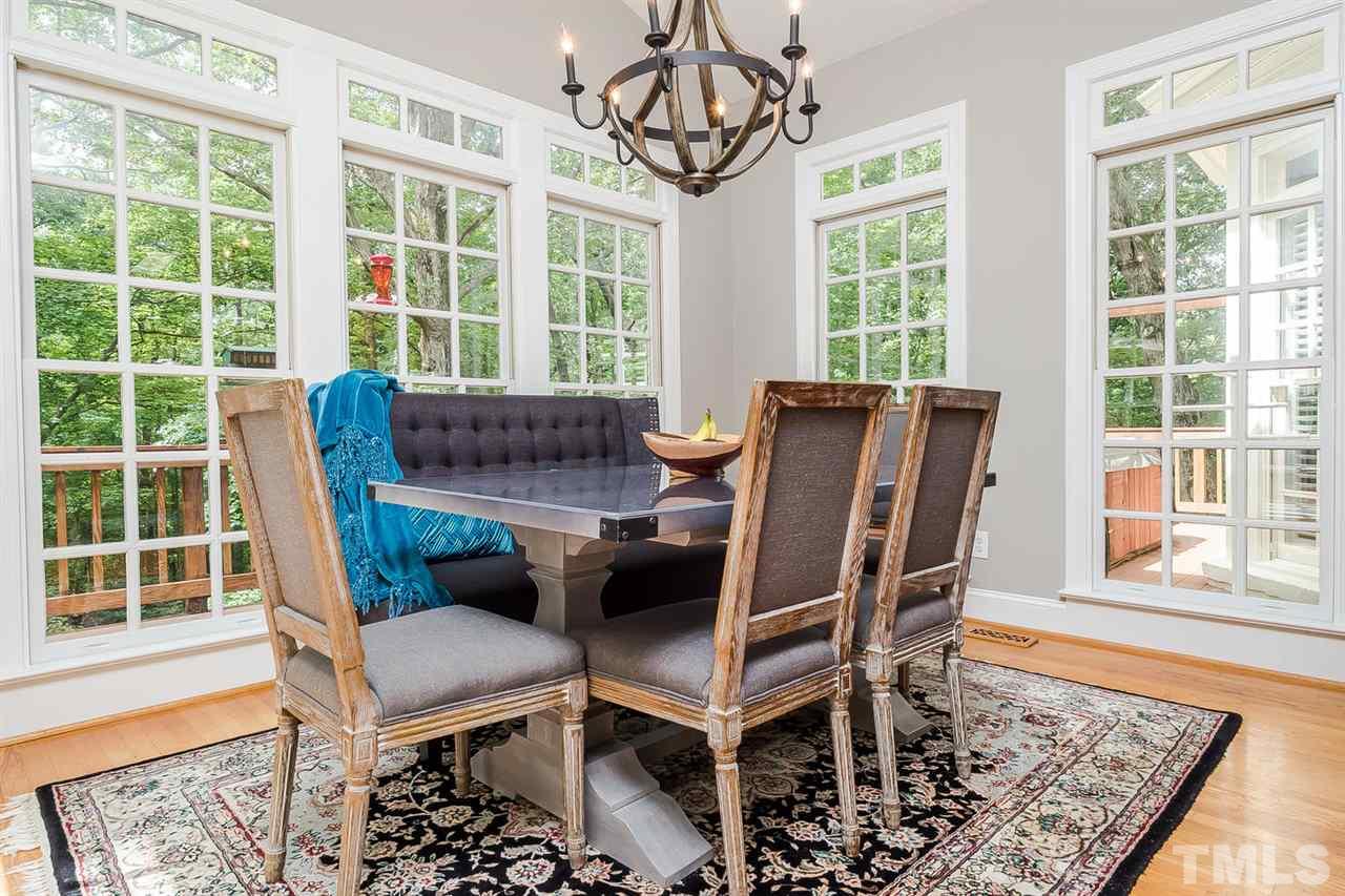 1105 Wagon Ridge Road Raleigh, NC 27614 - Photo 9 of 25 Breakfast room has a vaulted ceiling and walls of windows that overlook the deck.