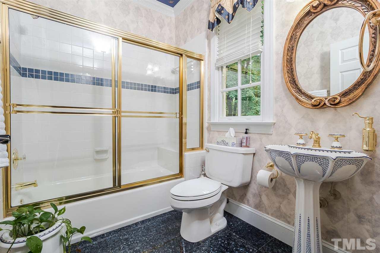 1105 Wagon Ridge Road Raleigh, NC 27614 - Photo 10 of 25 Guest bathroom on main level has granite tile flooring and "Russian Tea cup" sink. Closet is just outside the bathroom
