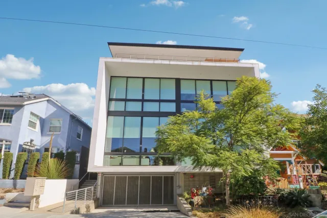 a front view of a building with a garden