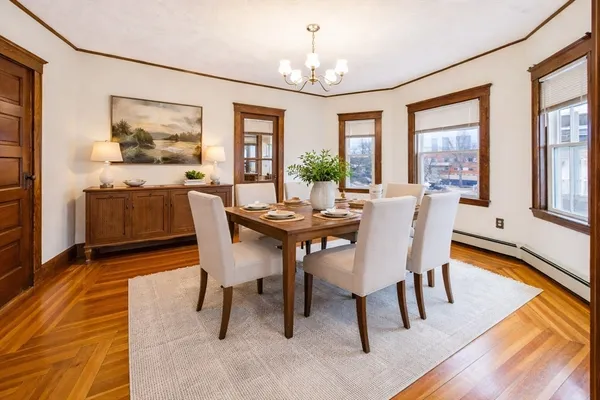 a view of a dining room with furniture window and wooden floor