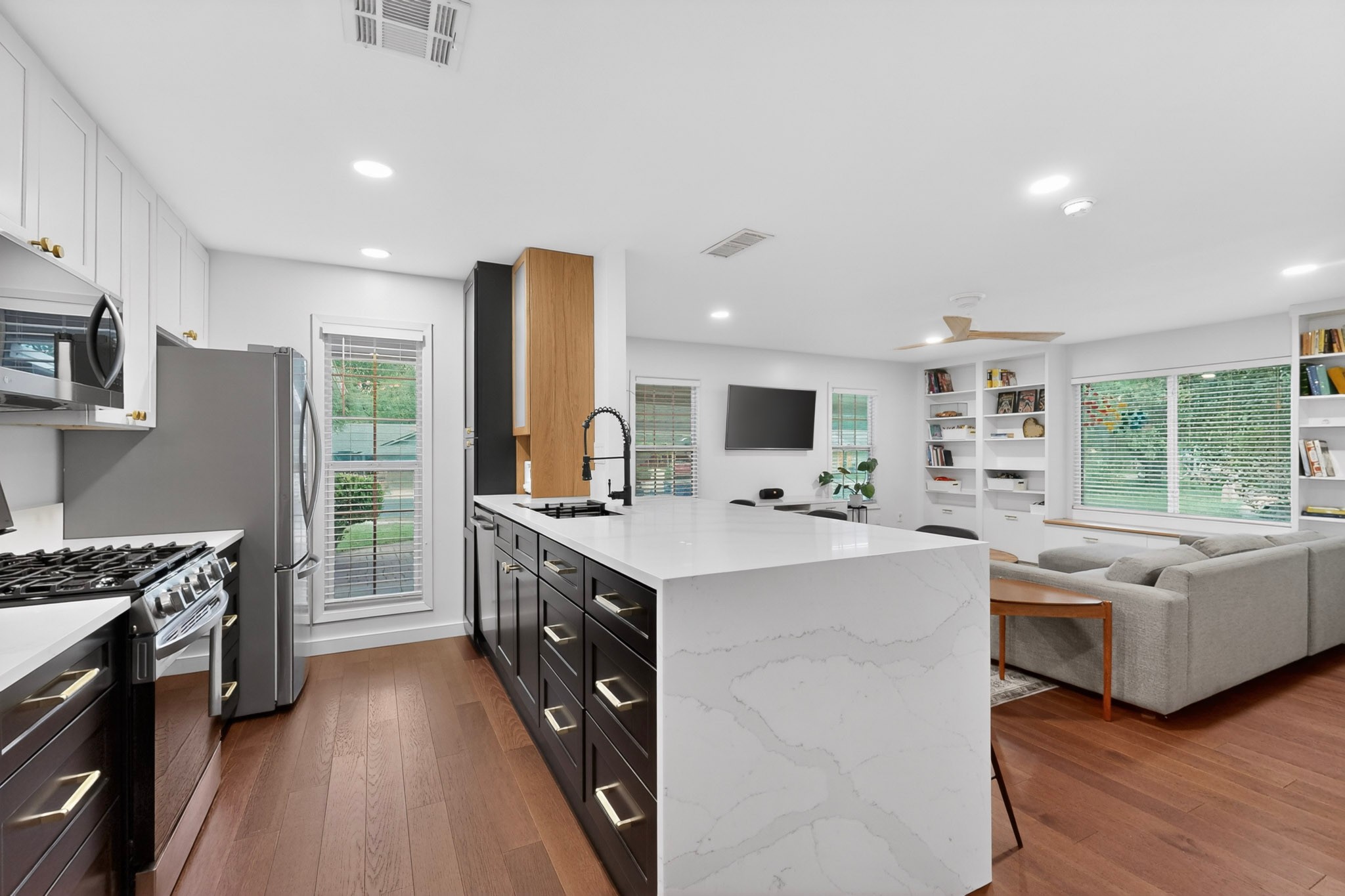 Open-concept living area featuring rich wood-finish flooring