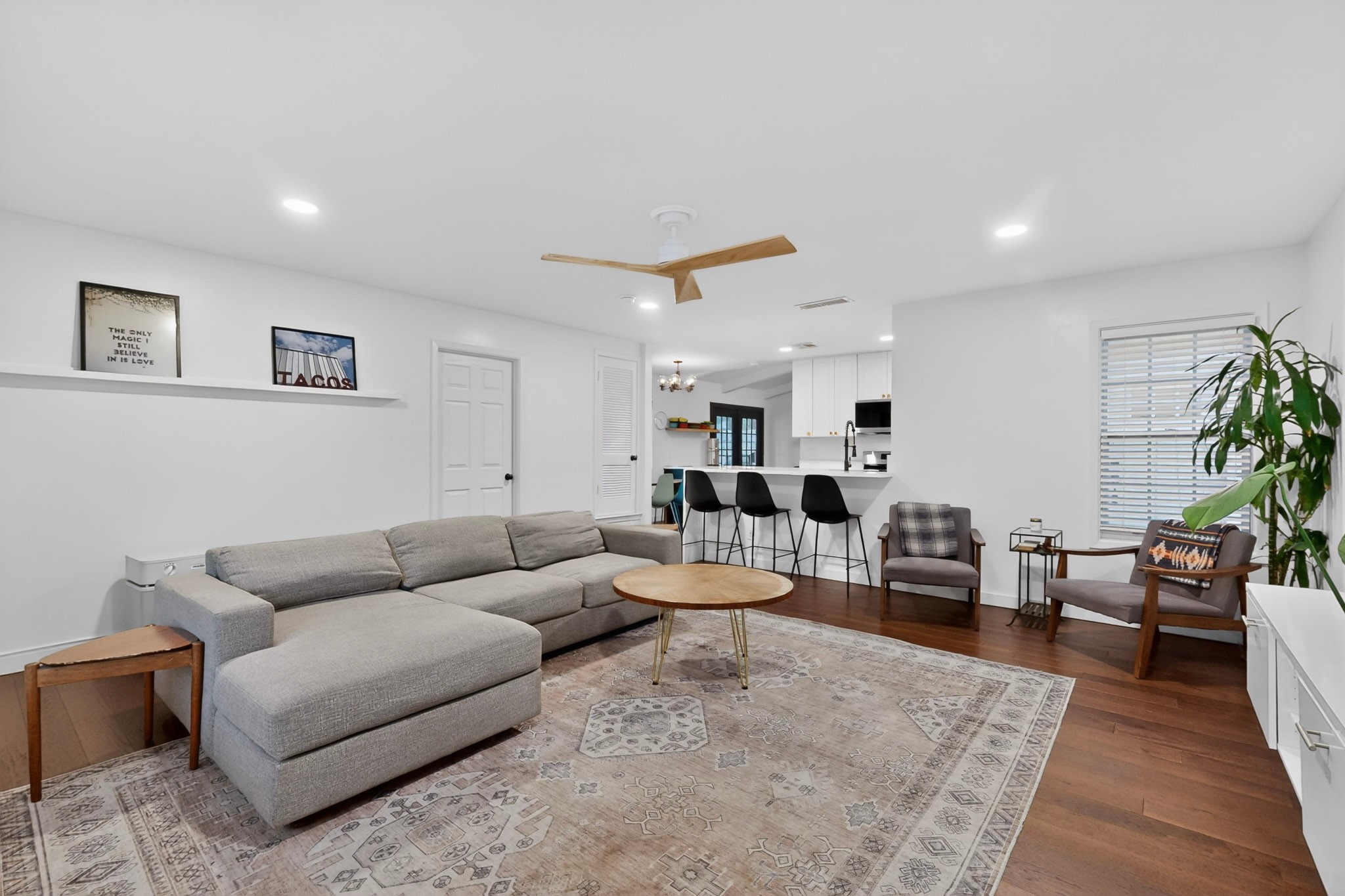 5541 Pine Place Austin, TX 78744 - Photo 15 of 33 Open-concept living area featuring rich wood-finish flooring, recessed lighting, and a contemporary ceiling fan