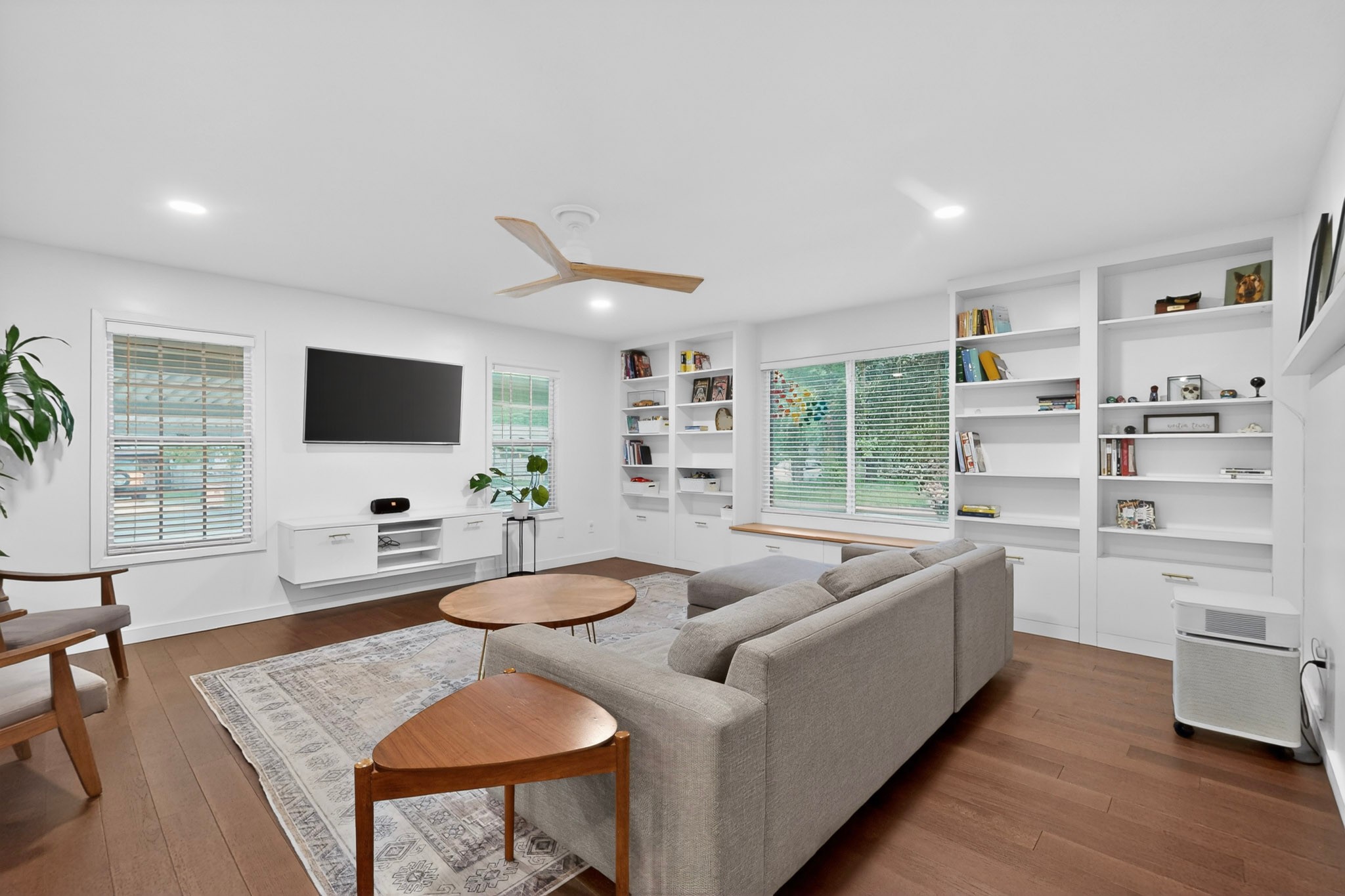 5541 Pine Place Austin, TX 78744 - Photo 16 of 33 Living area featuring wood-finish flooring, recessed lighting, and a modern ceiling fan