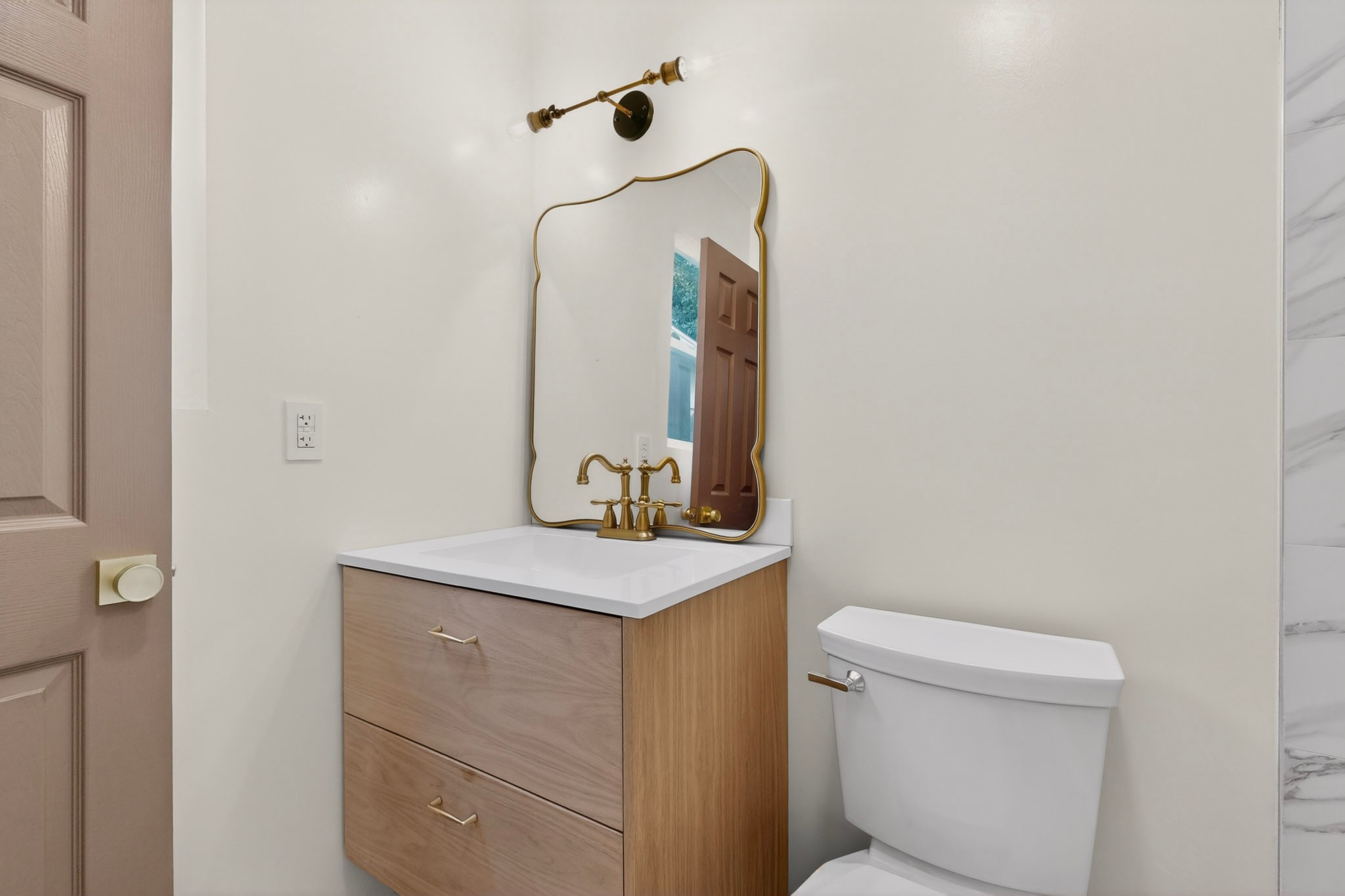 5541 Pine Place Austin, TX 78744 - Photo 21 of 33 Bathroom vanity featuring a light wood-finish cabinet with two drawers, a white countertop, and a white integrated rectangular sink