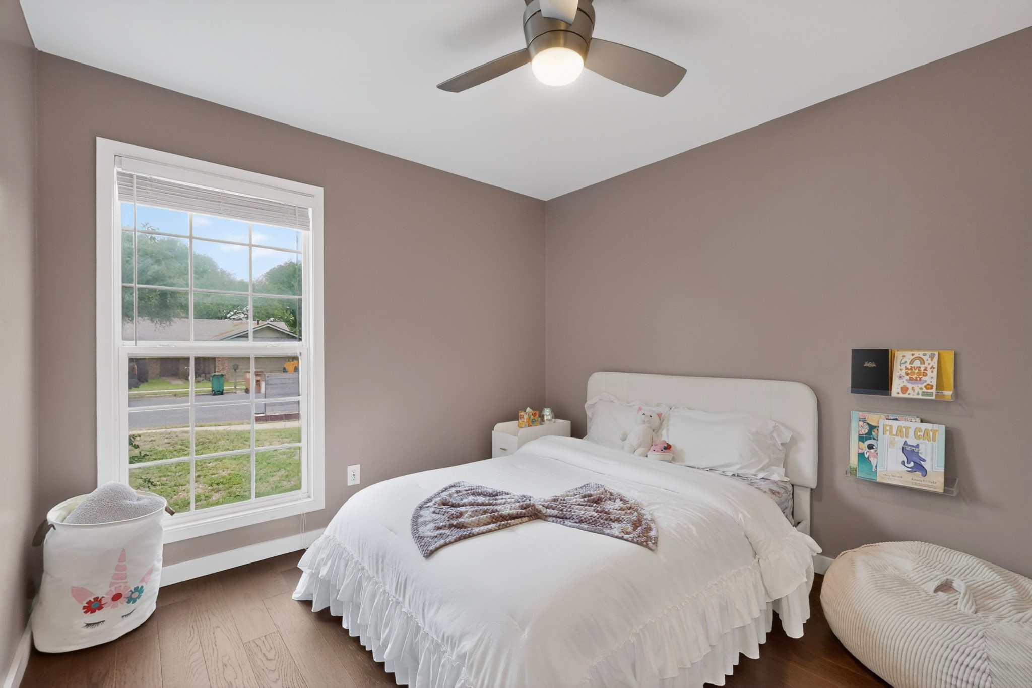 5541 Pine Place Austin, TX 78744 - Photo 24 of 33 Bedroom featuring wood-finish flooring, a contemporary ceiling fan with integrated lighting, and neutral wall paint