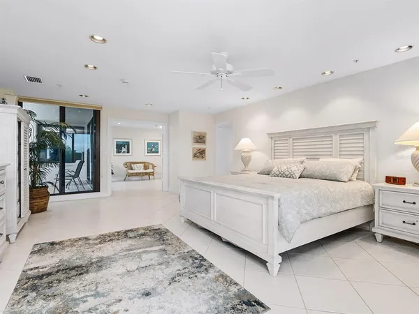 a spacious bedroom with a bed and a dresser