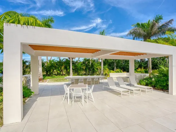 a view of a patio with table and chairs under an umbrella