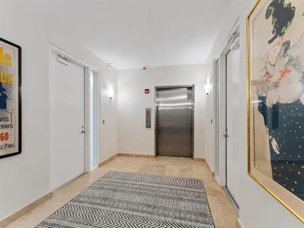 a view of a hallway with seating area