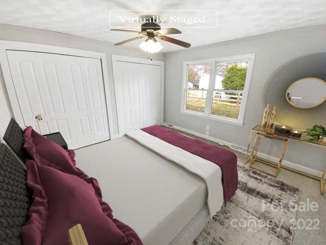 4408 Griffith Road Monroe, NC 28112 - Photo 4 of 17 a bedroom with a bed and a chandelier