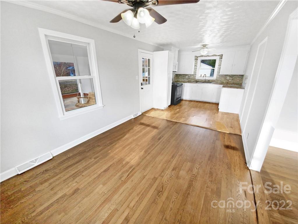 4408 Griffith Road Monroe, NC 28112 - Photo 10 of 17 a view of a kitchen with wooden floor and a ceiling fan
