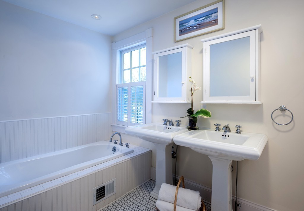 6 Leavitt Street Hingham, MA 02043 - Photo 14 of 28 a bathroom with a bathtub a sink and a window