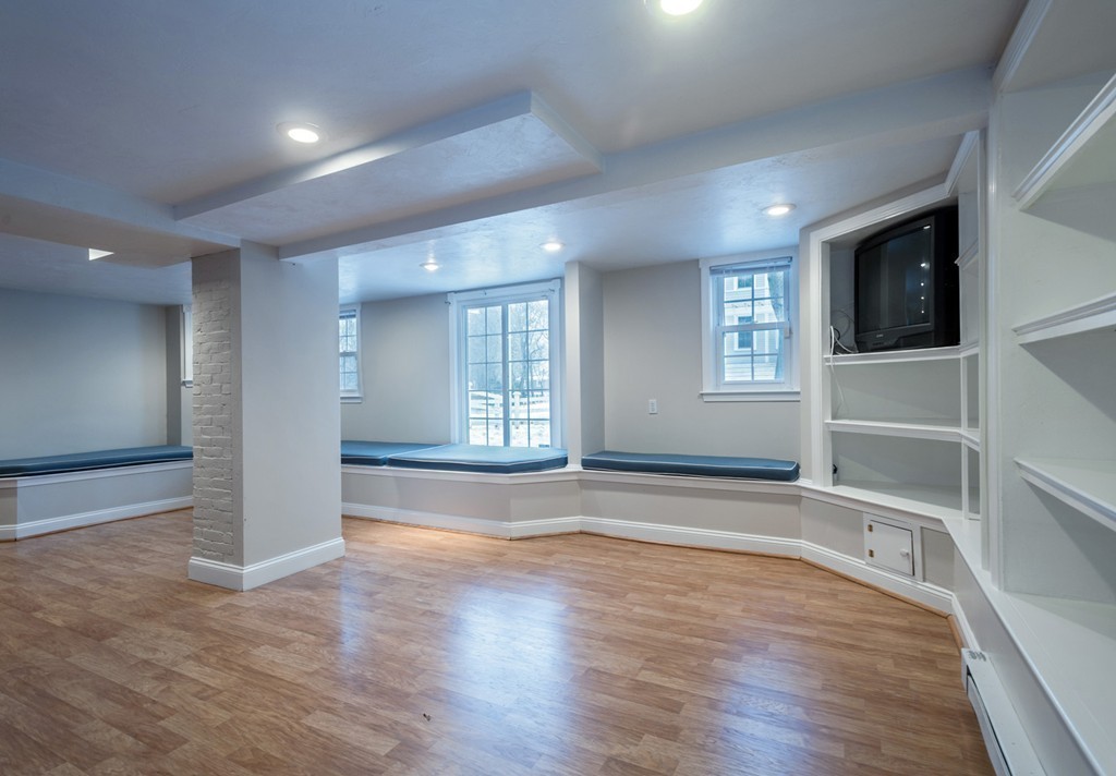 6 Leavitt Street Hingham, MA 02043 - Photo 22 of 28 an empty room with wooden floor and windows