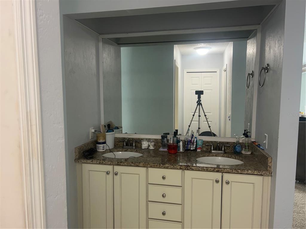 357 Tymber Run Ormond Beach, FL 32174 - Photo 8 of 32 a bathroom with a granite countertop sink and a mirror