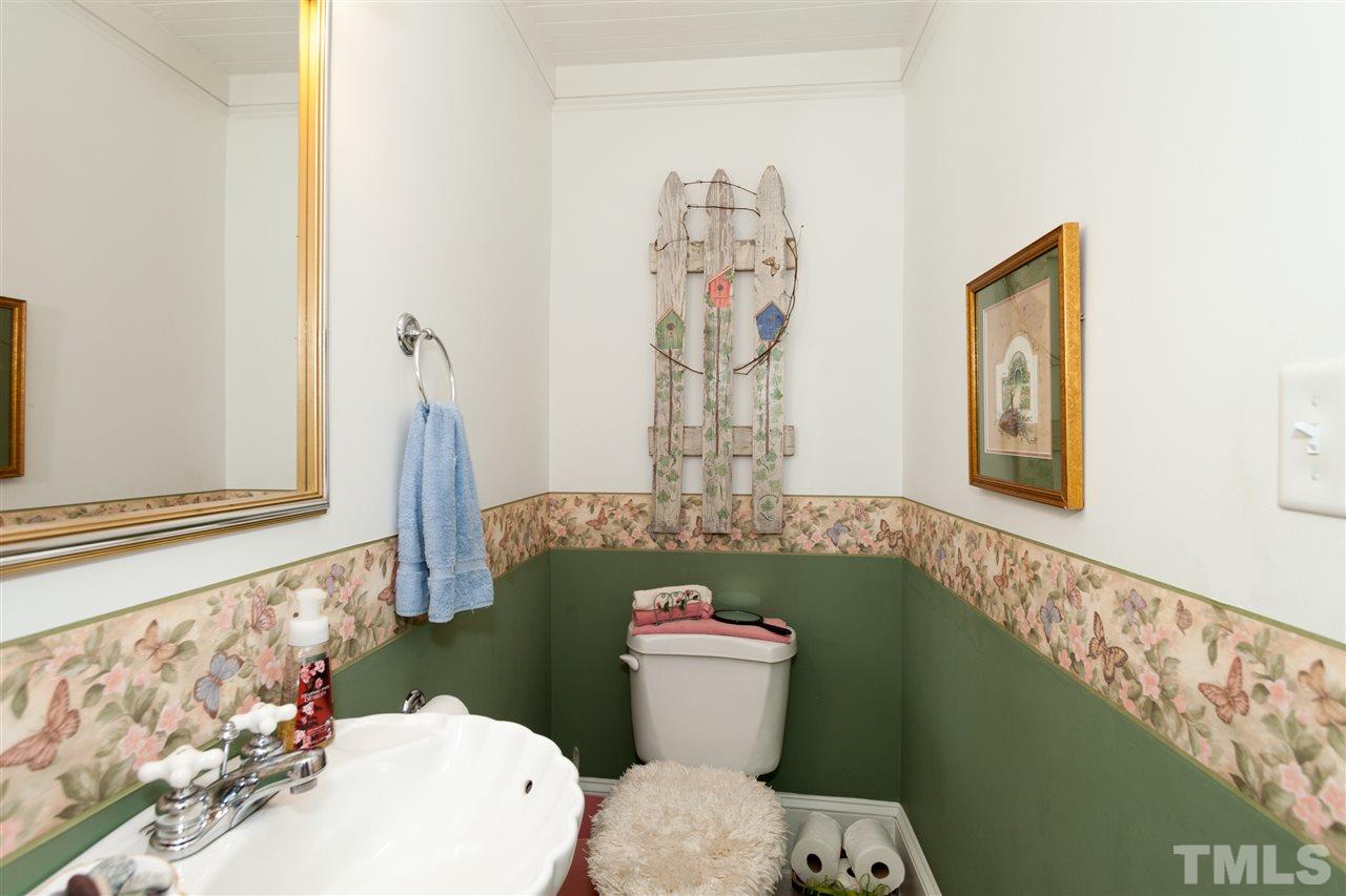 365 Rassie Crabtree Road Rougemont, NC 27572 - Photo 14 of 25 a white toilet sitting next to a shower curtain