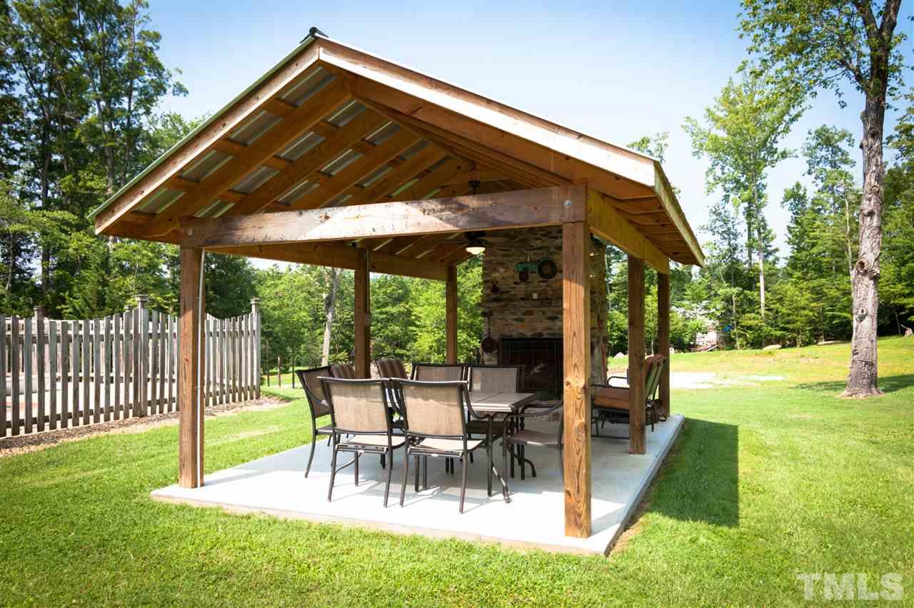 365 Rassie Crabtree Road Rougemont, NC 27572 - Photo 22 of 25 a view of a backyard with a patio and swimming pool