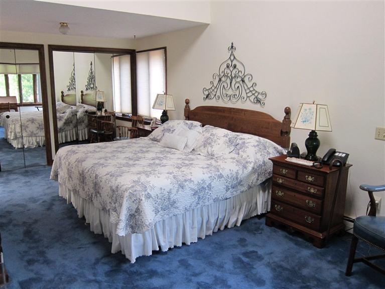 495 Elliott Road Centerville, MA 02632 - Photo 12 of 17 a bedroom with a bed and a chandelier