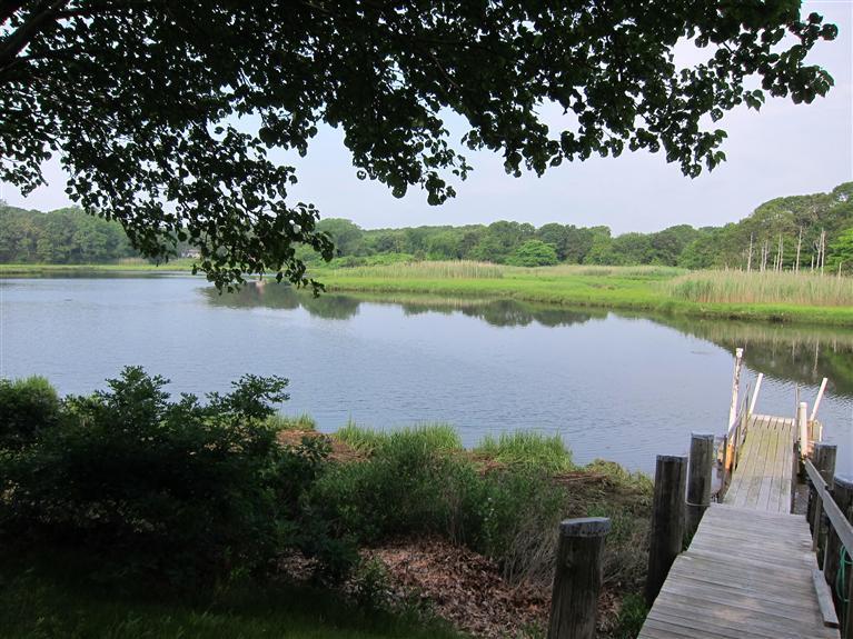 495 Elliott Road Centerville, MA 02632 - Photo 5 of 17 a view of a lake with a garden