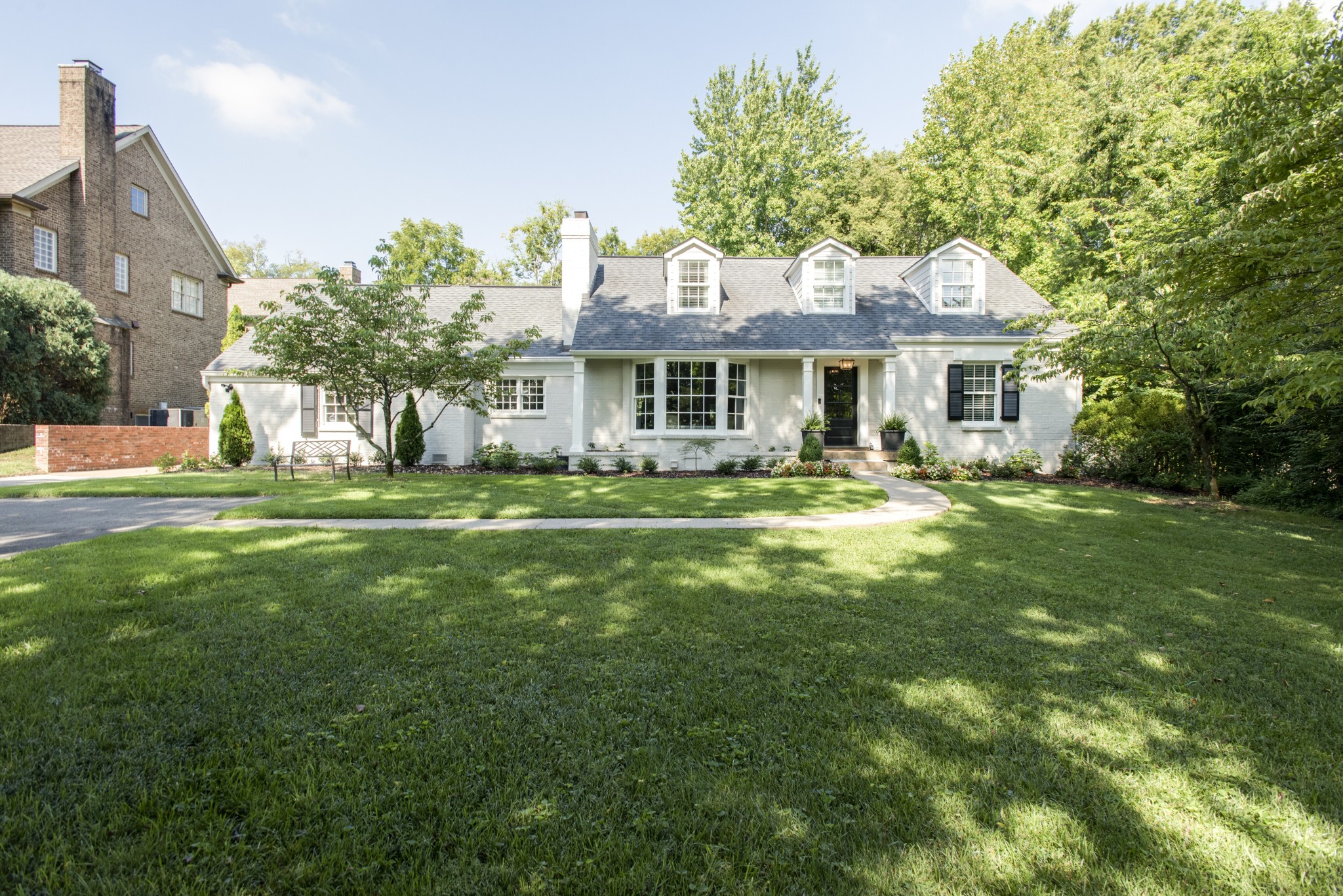 a front view of house with yard and green space