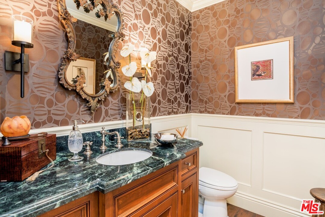 826 Greentree Road Pacific Palisades, CA 90272 - Photo 11 of 29 a bathroom with a granite countertop sink and a toilet