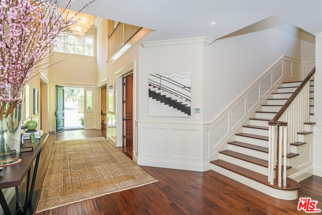 826 Greentree Road Pacific Palisades, CA 90272 - Photo 12 of 29 a view of a hallway with wooden floor and staircase