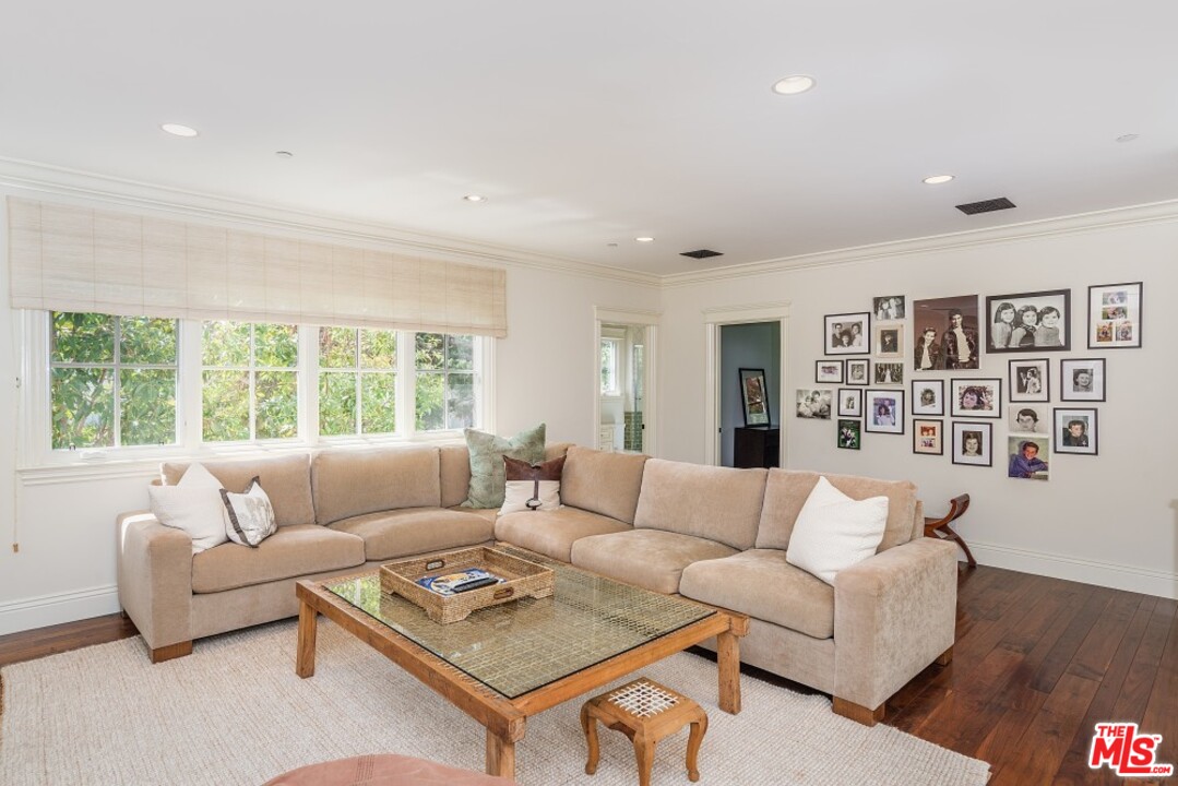 826 Greentree Road Pacific Palisades, CA 90272 - Photo 13 of 29 a living room with furniture and a large window