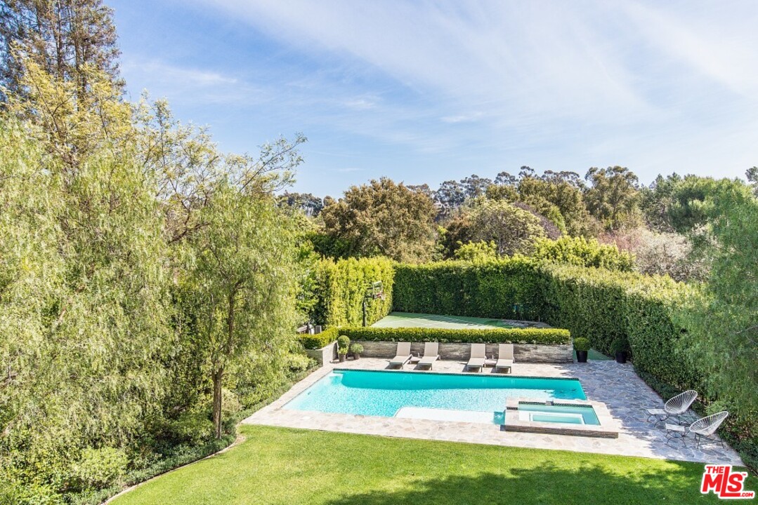 826 Greentree Road Pacific Palisades, CA 90272 - Photo 18 of 29 a view of yard with swimming pool and trees in the background