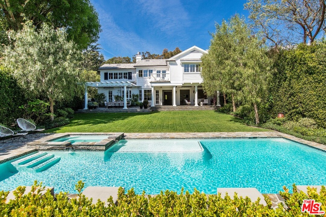 826 Greentree Road Pacific Palisades, CA 90272 - Photo 23 of 29 a view of a house with a yard table and chairs