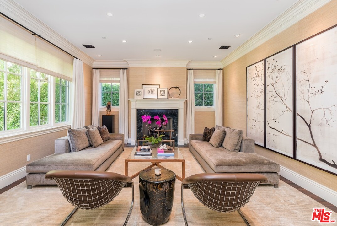 826 Greentree Road Pacific Palisades, CA 90272 - Photo 5 of 29 a living room with furniture a floor to ceiling window and a flat screen tv