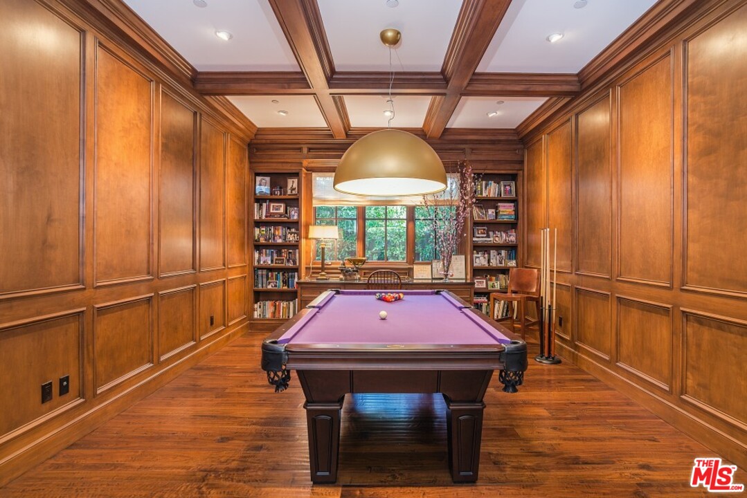 826 Greentree Road Pacific Palisades, CA 90272 - Photo 7 of 29 a table and chairs in a room with a fireplace
