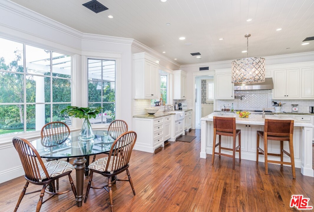 826 Greentree Road Pacific Palisades, CA 90272 - Photo 9 of 29 a dining room with furniture a window and wooden floor