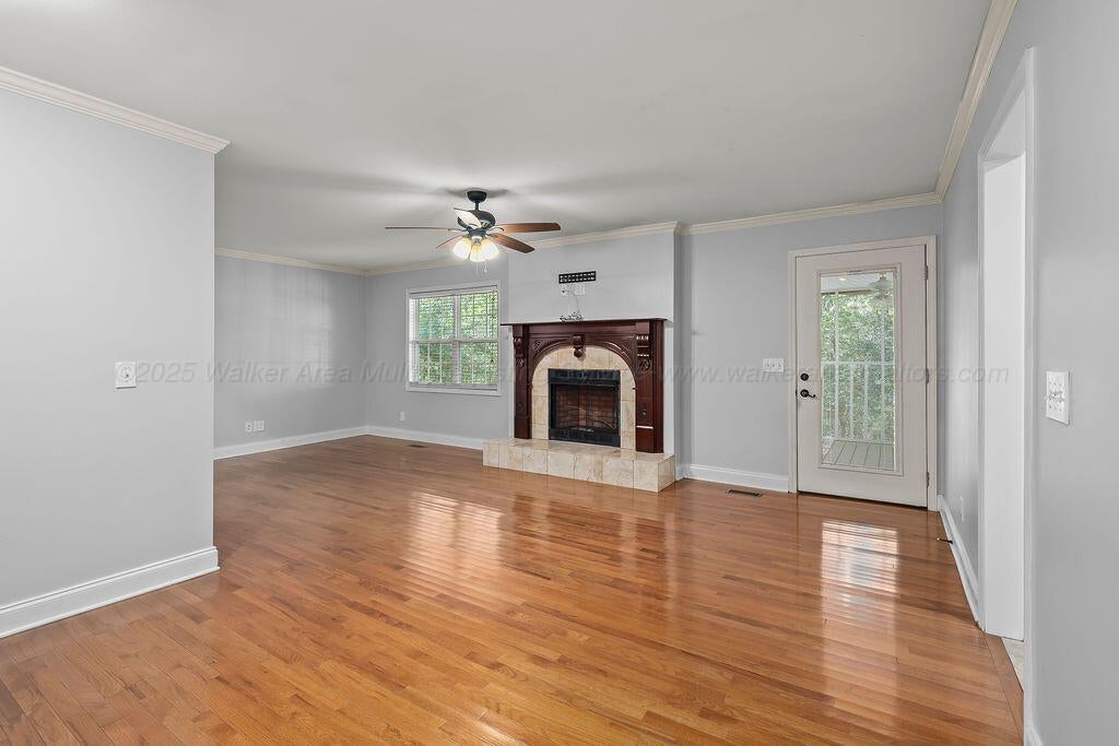 2608 Briarcliff Road Jasper, AL 35504 - Photo 3 of 26 Large family room with fireplace and exterior door to screened porch.