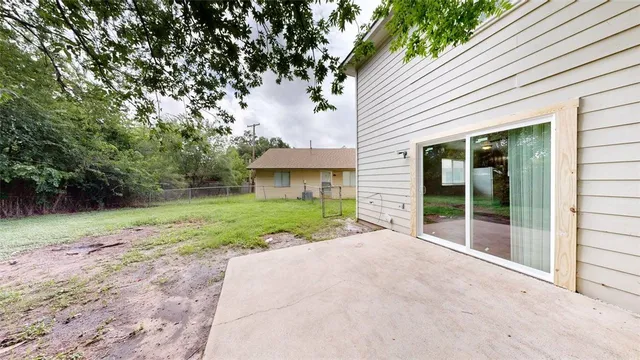 a front view of a house with a yard and potted plants
