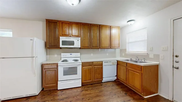 a kitchen with stainless steel appliances granite countertop a stove a refrigerator and a microwave