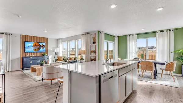 a room with lots of tables a large window and chairs