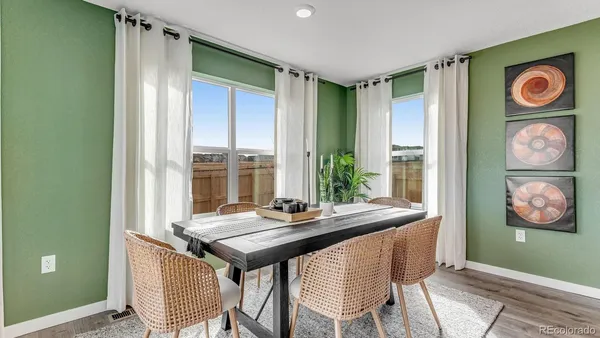a view of a dining room with a table and chairs